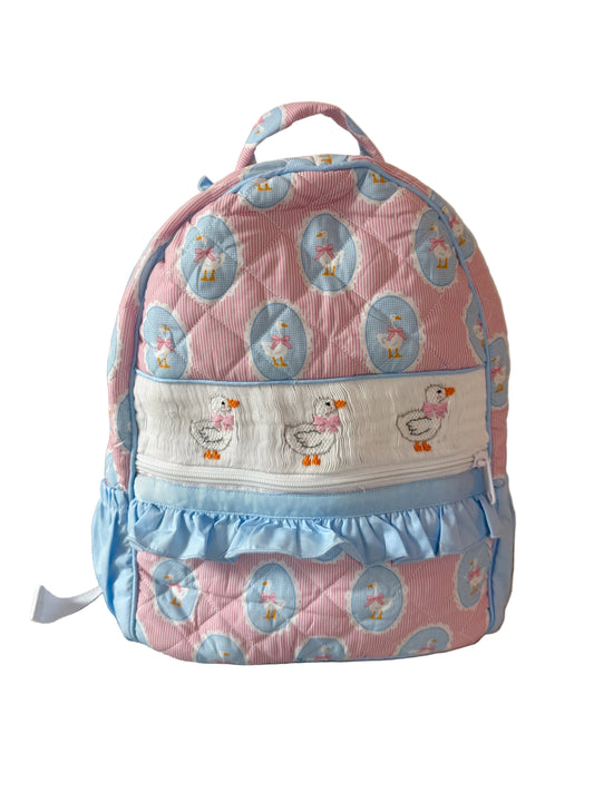 Children's backpack with duck pattern on a beige background